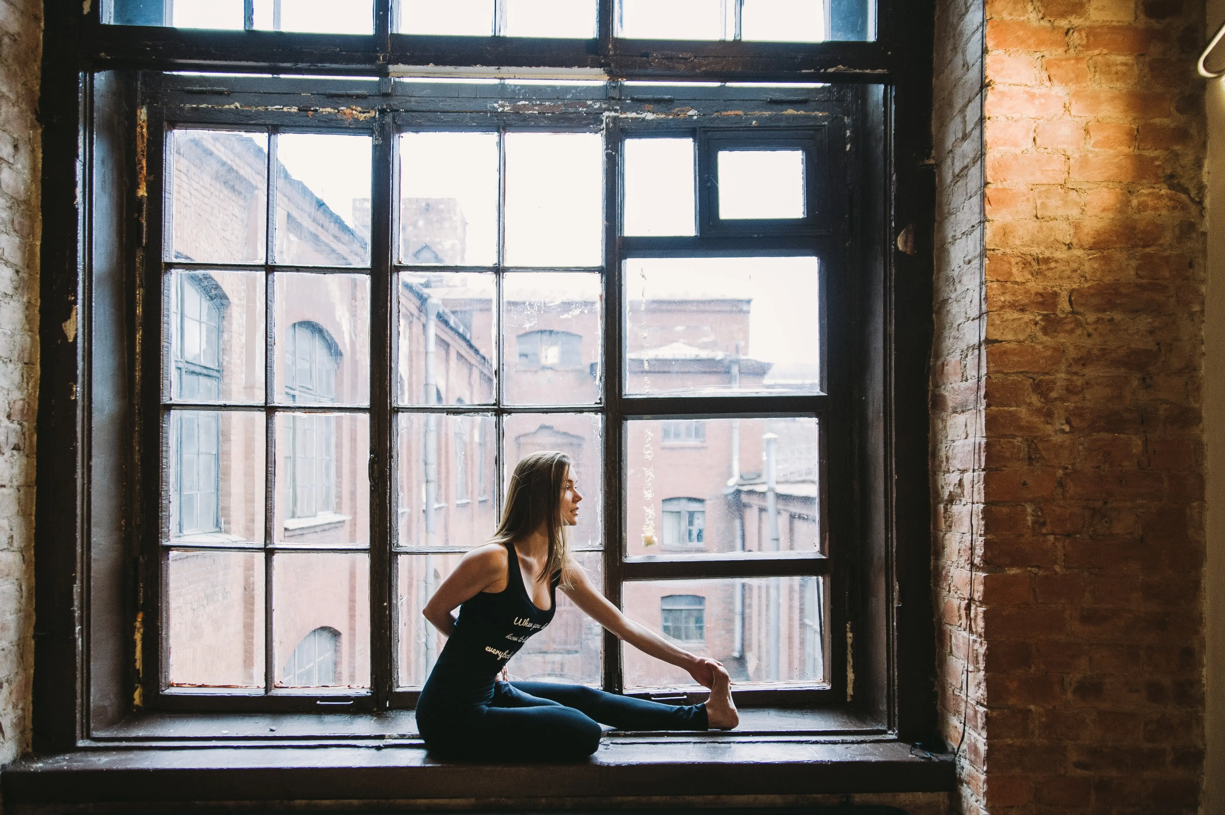 woman standing in front on huge window